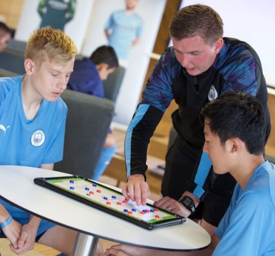 Manchester City Academy Coaches teaching players in class