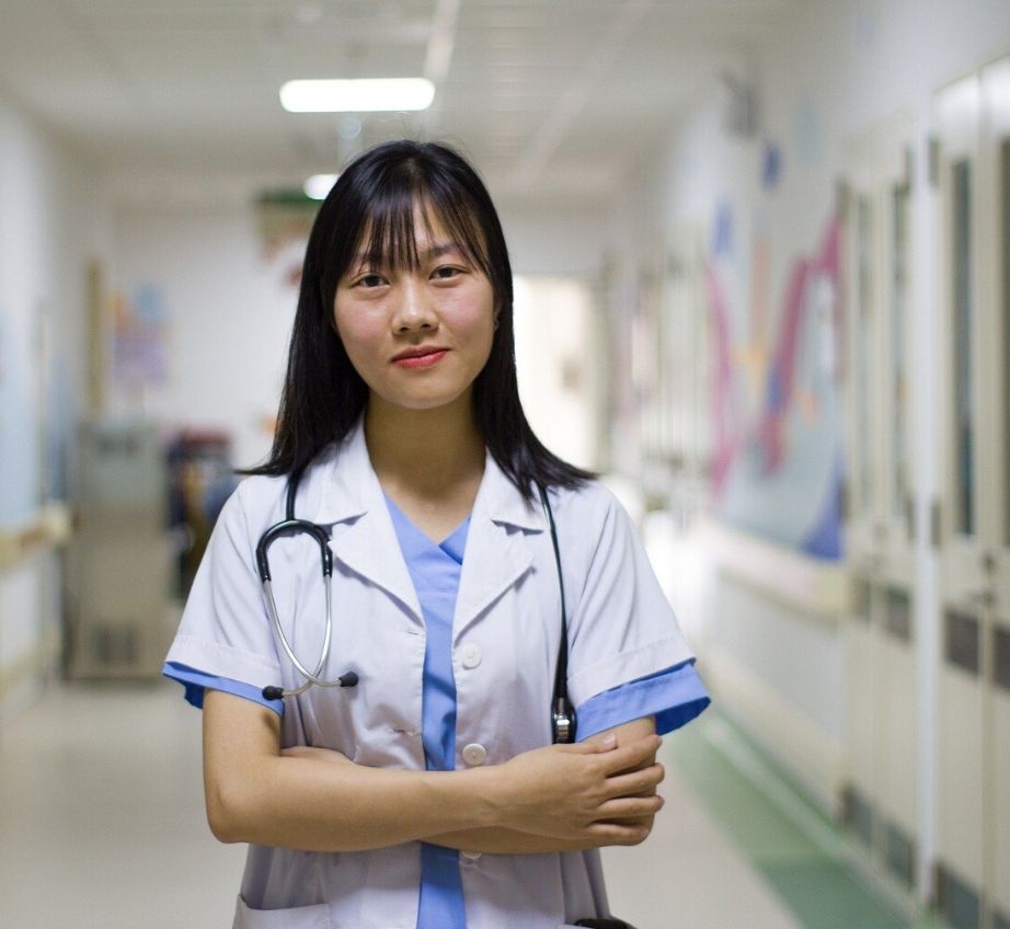 Female doctor on a hospital ward with a stethoscope