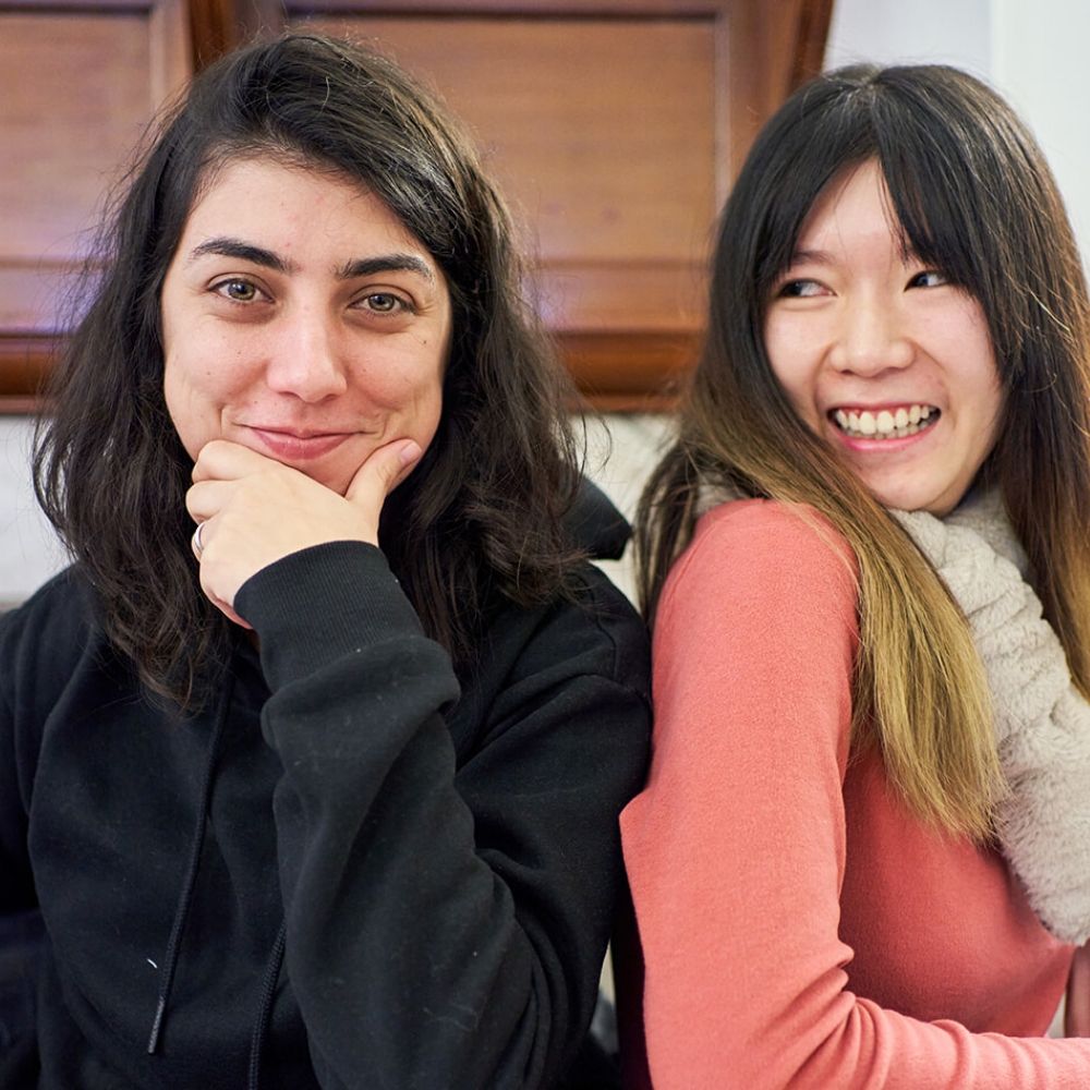 Two women in a classroom in BSC London sat side by side
