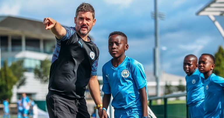 Manchester City Academy coach talking to young player