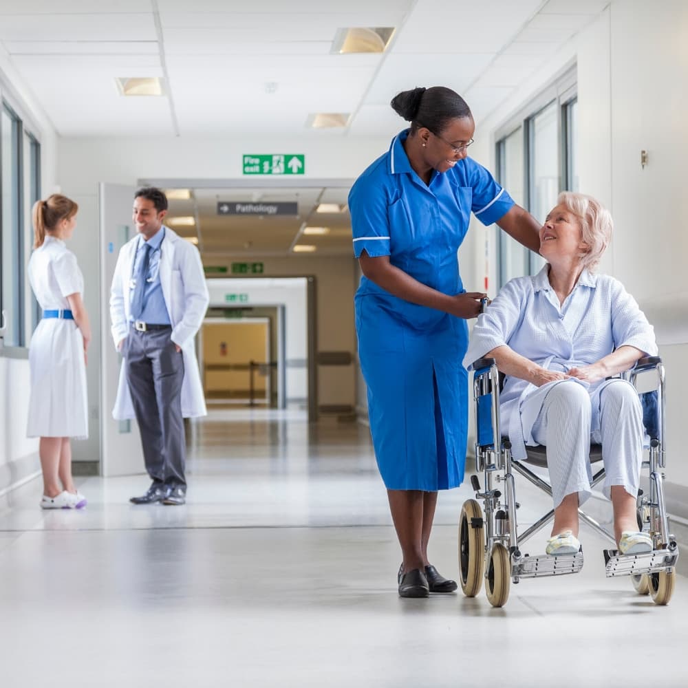 nurse speaking with patient in wheelchair