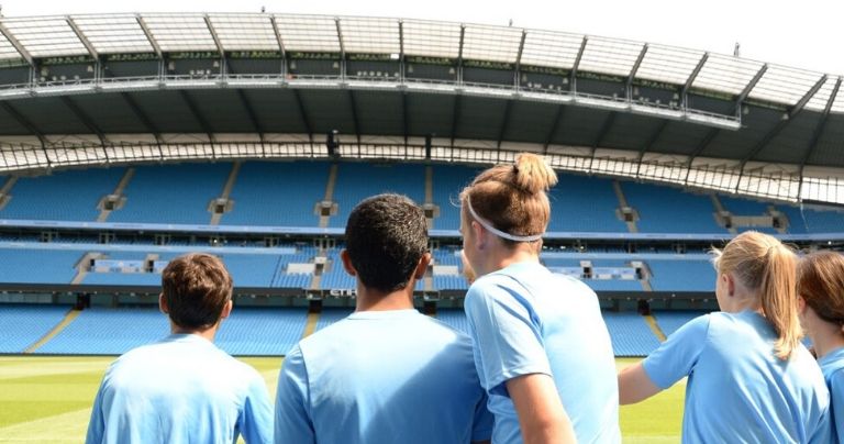 Young players taking a tour of the Etihad Stadium
