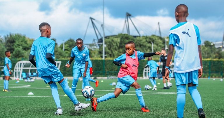 Younger boys football training in Manchester City kit