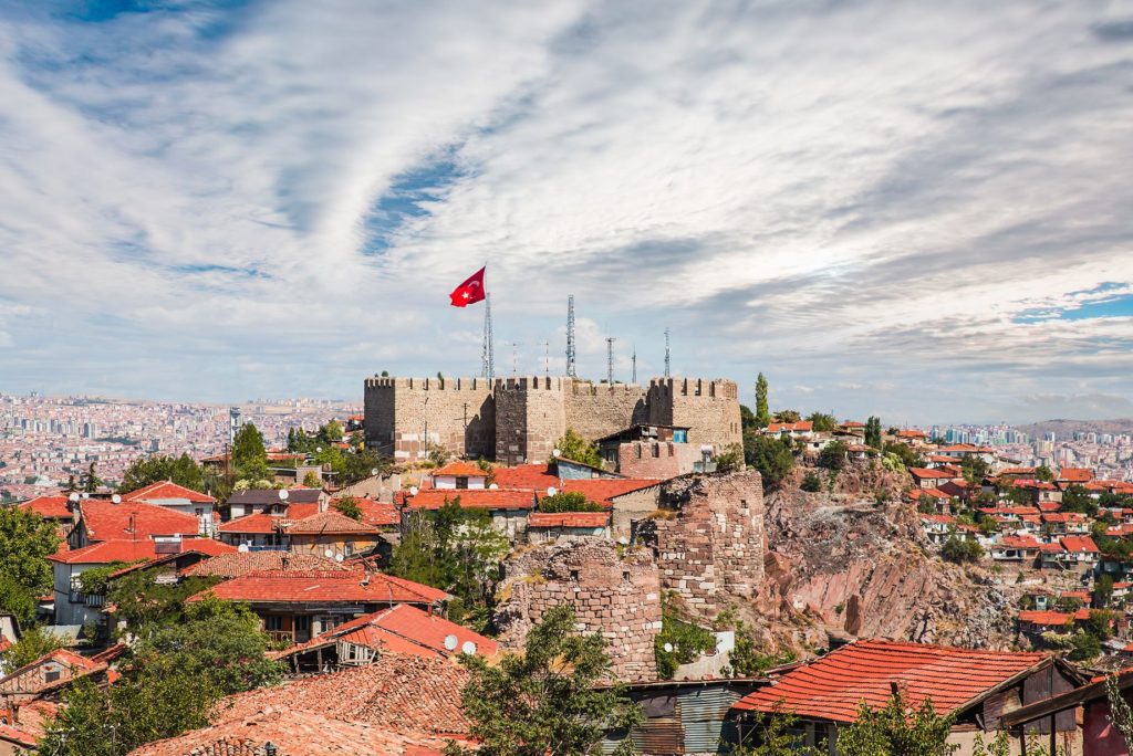 Picture of hilltop fort flying the Turkish flag overlooking a town