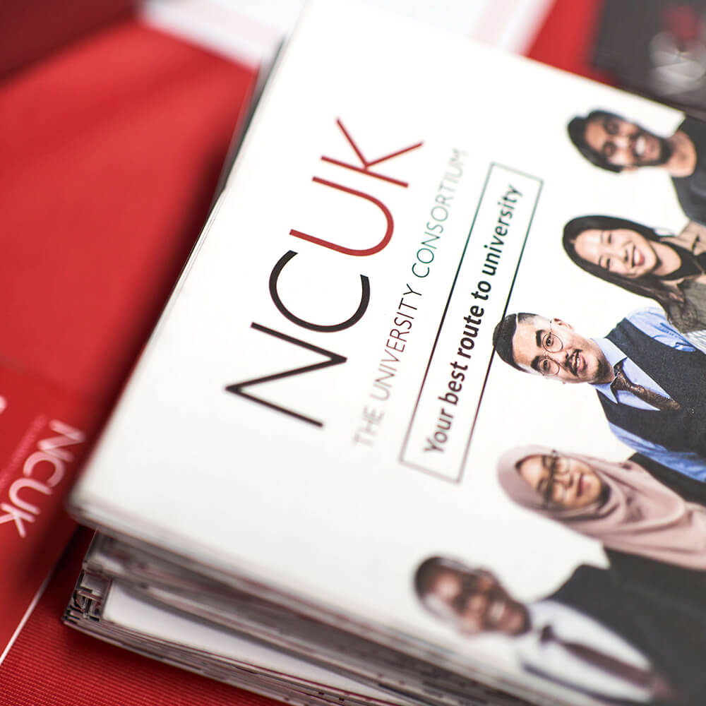 NCUK brochures on red table cloth