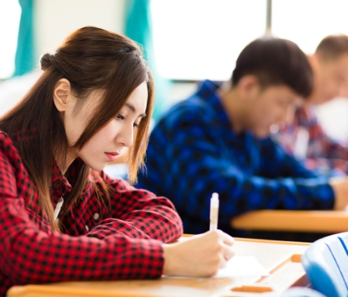 woman in red shirt taking an english exam