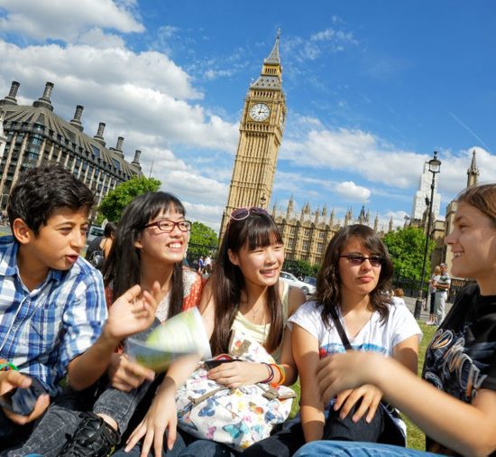 Young students on a summer school in London, sat outside of Westminster
